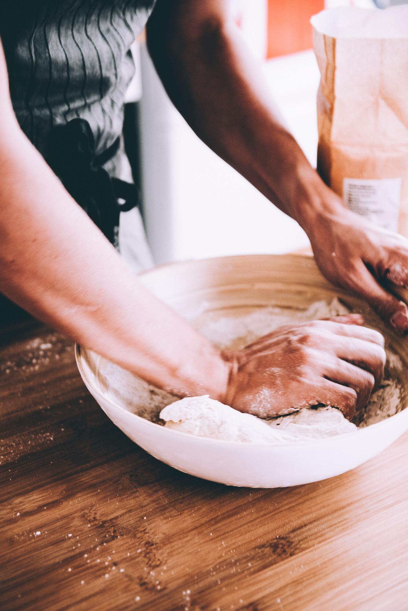 Close-up: hands kneading dough